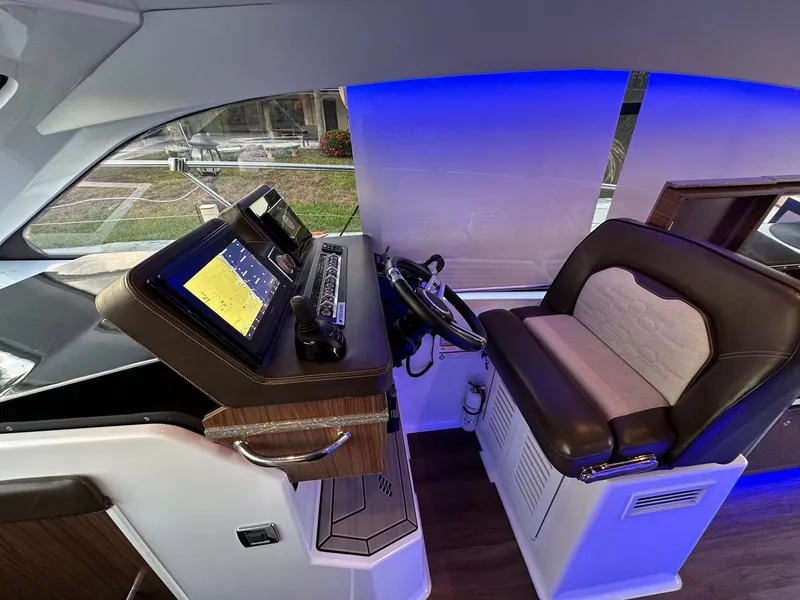 Slide: The Image of Helm of 2020 Four Winns Vista 355 Coupe with modern controls and seating. - 33