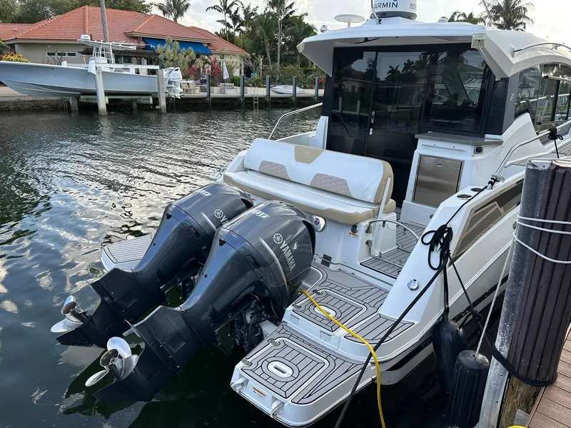 Slide: The Image of 2020 Four Winns Vista 355 Coupe docked with dual outboard engines. - 6