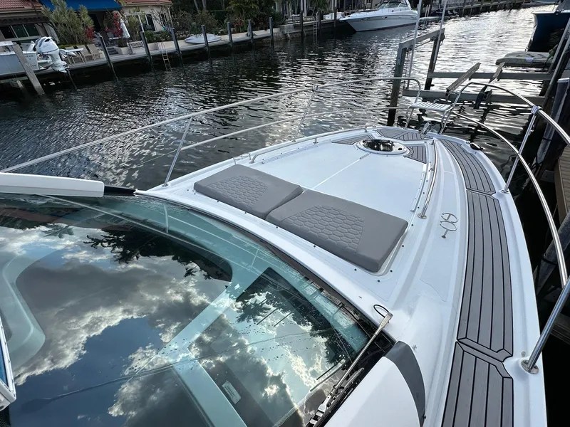 Slide: The Image of 2020 Four Winns Vista 355 Coupe docked by a serene waterfront. - 8