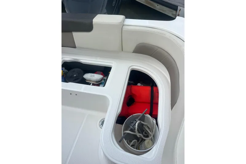 Slide: The Image of Storage compartments on a 2021 Robolo 242EX boat, featuring life jackets and ropes. - 10