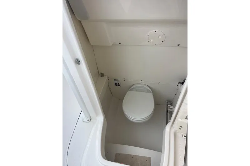 Slide: The Image of Robolo 242EX 2021 boat interior with compact marine toilet. - 11
