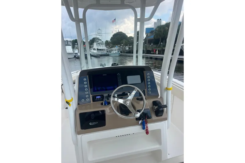 Slide: The Image of Robolo 242EX 2021 boat dashboard with steering wheel and control panel at marina. - 12