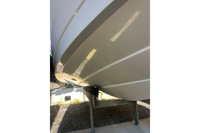 Slide: The Image of Close-up of 2021 Robolo 242EX boat hull on a stand, showing sleek design. - 16