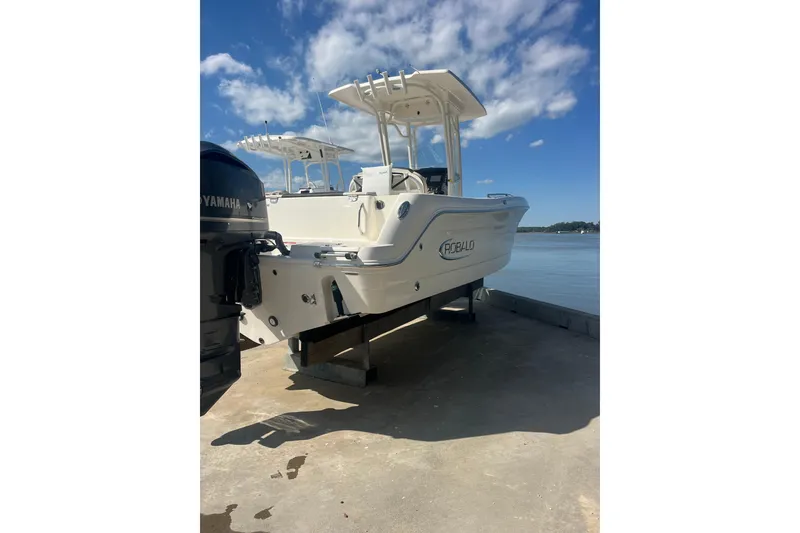 Slide: The Image of 2021 Robolo 242EX boat docked by the water under a clear blue sky. - 3