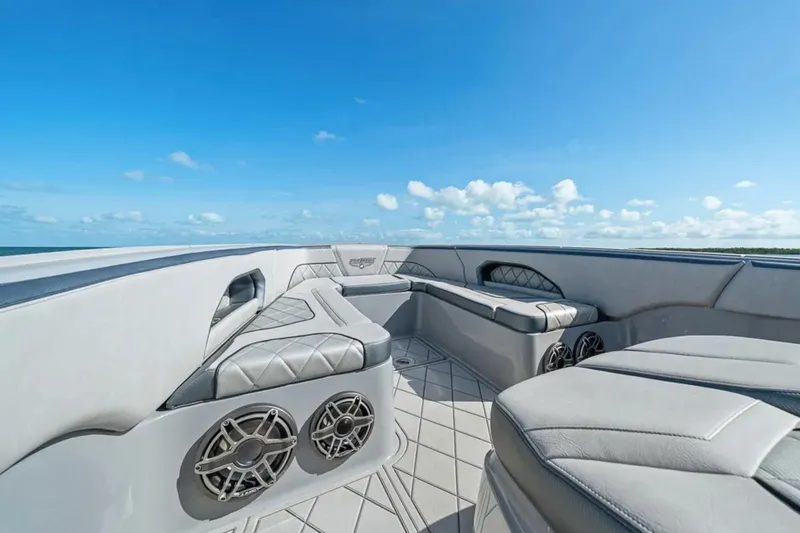 Slide: The Image of Luxurious seating on 2025 Deep Impact 369 Sport boat under clear blue sky. - 12