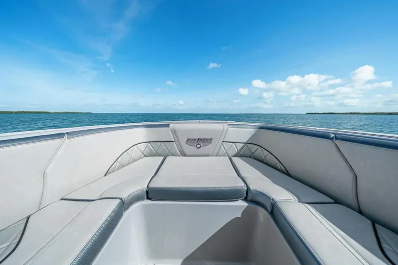 Slide: The Image of 2025 Deep Impact 369 Sport boat interior with ocean view under clear blue sky. - 13