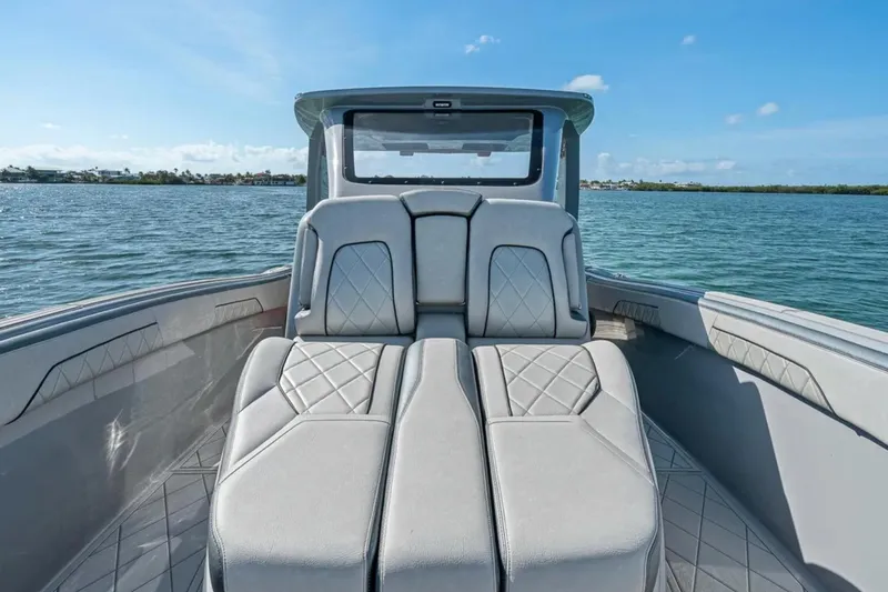 Slide: The Image of 2025 Deep Impact 369 Sport boat interior with luxurious seating on a sunny day. - 19