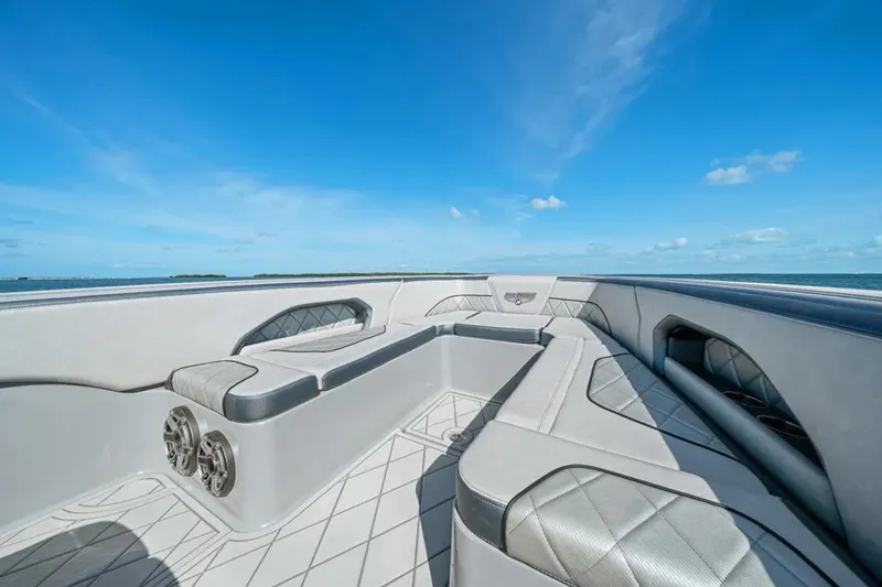 Slide: The Image of 2025 Deep Impact 369 Sport boat interior with luxurious seating and ocean view. - 20