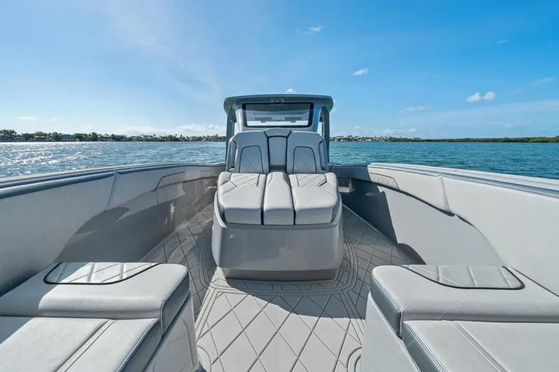 Slide: The Image of 2025 Deep Impact 369 Sport boat interior with luxurious seating on a sunny day. - 24
