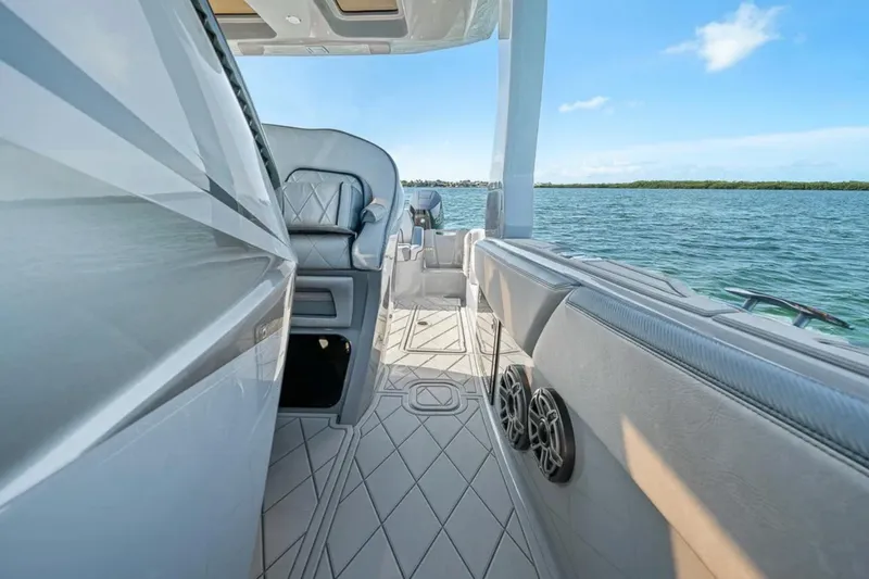 Slide: The Image of 2025 Deep Impact 369 Sport boat interior with luxurious seating and ocean view. - 26