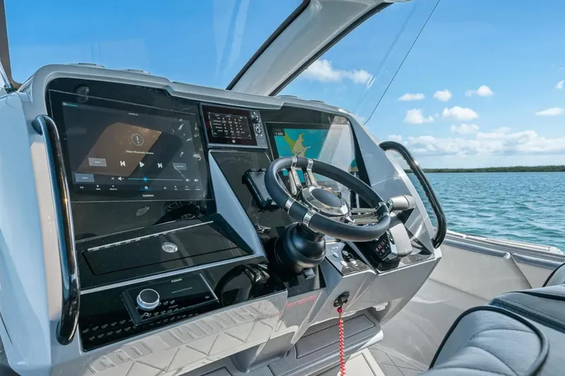 Slide: The Image of Helm of 2025 Deep Impact 369 Sport boat with advanced navigation displays. - 29