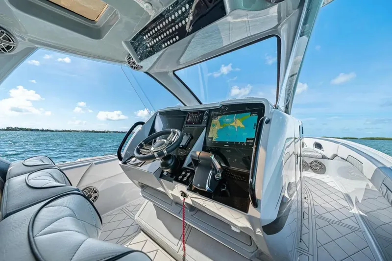 Slide: The Image of 2025 Deep Impact 369 Sport boat cockpit with advanced navigation system on open water. - 32
