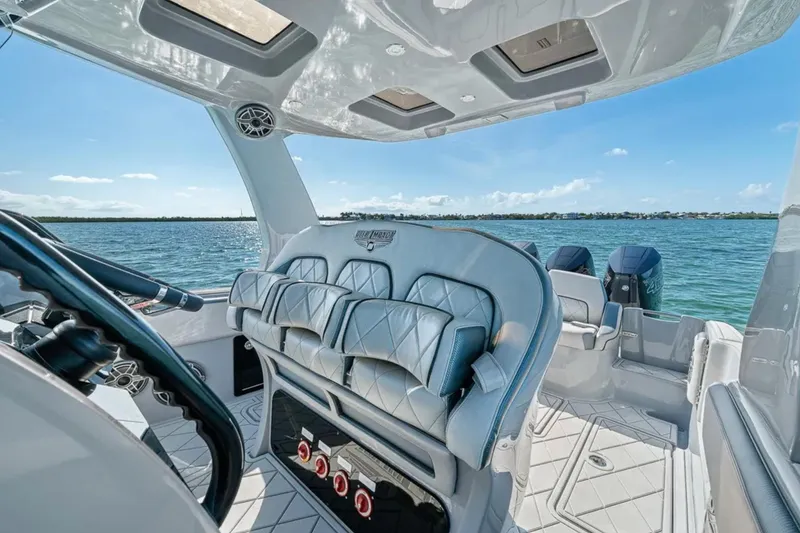Slide: The Image of Interior view of 2025 Deep Impact 369 Sport boat with luxurious seating and ocean backdrop. - 35