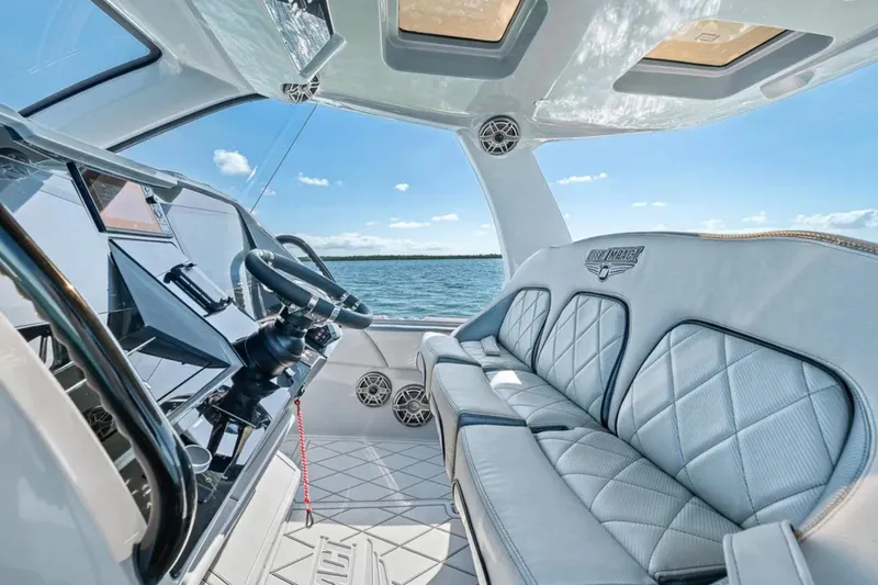 Slide: The Image of Luxurious interior of 2025 Deep Impact 369 Sport boat with plush seating and modern dashboard. - 36