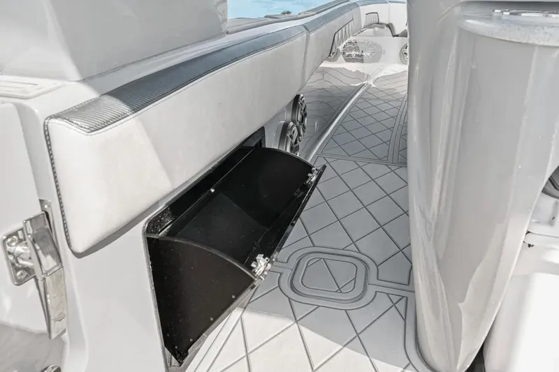 Slide: The Image of 2025 Deep Impact 369 Sport boat interior with open storage compartment and sleek design. - 43