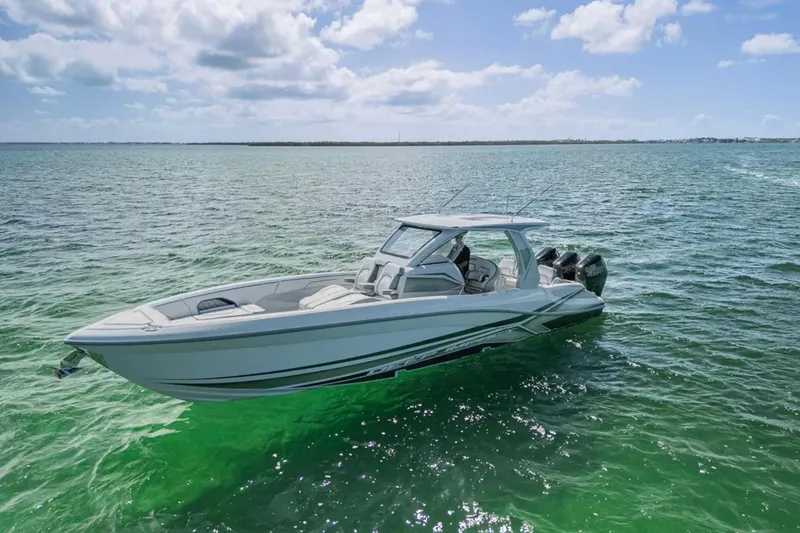 Slide: The Image of 2025 Deep Impact 369 Sport boat cruising on clear, sunny waters. - 55