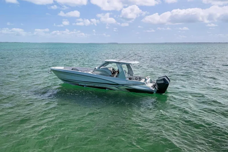 Slide: The Image of 2025 Deep Impact 369 Sport boat on clear ocean water under blue sky. - 56