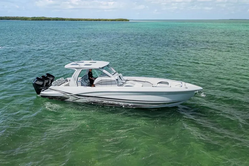 Slide: The Image of 2025 Deep Impact 369 Sport boat cruising on clear turquoise waters. - 6