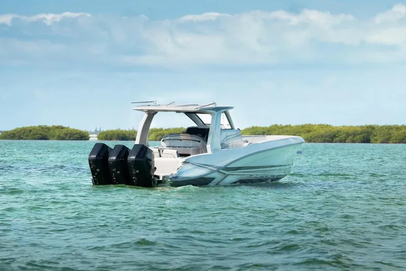 Slide: The Image of 2025 Deep Impact 369 Sport boat on calm water, featuring triple outboard engines. - 60