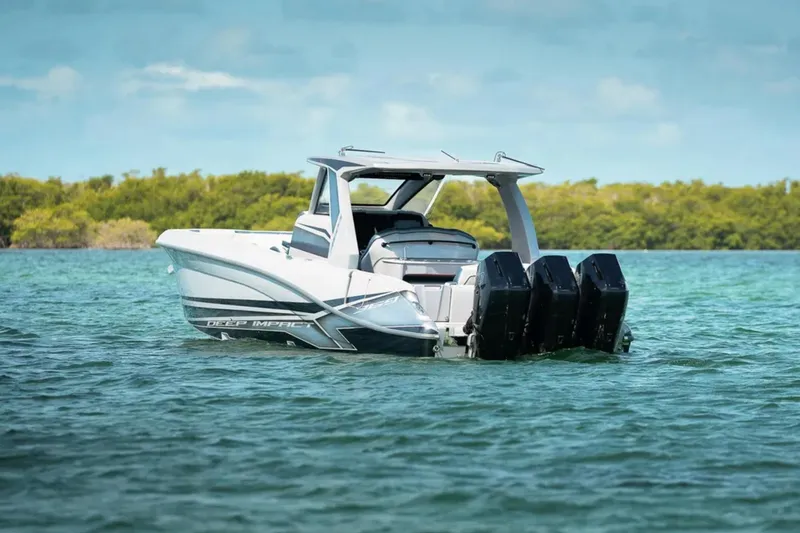 Slide: The Image of 2025 Deep Impact 369 Sport boat on water, featuring sleek design and powerful engines. - 61