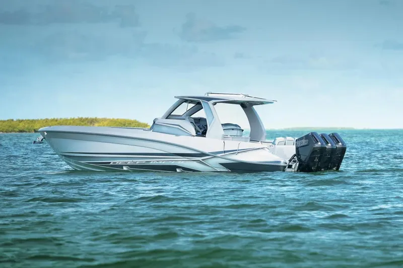 Slide: The Image of 2025 Deep Impact 369 Sport boat on calm blue water, showcasing sleek design and powerful engines. - 62