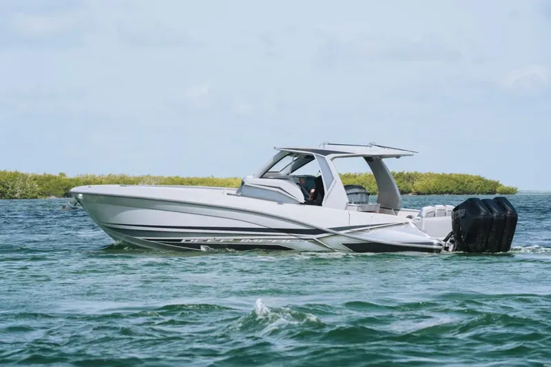 Slide: The Image of 2025 Deep Impact 369 Sport boat cruising on clear blue water. - 66