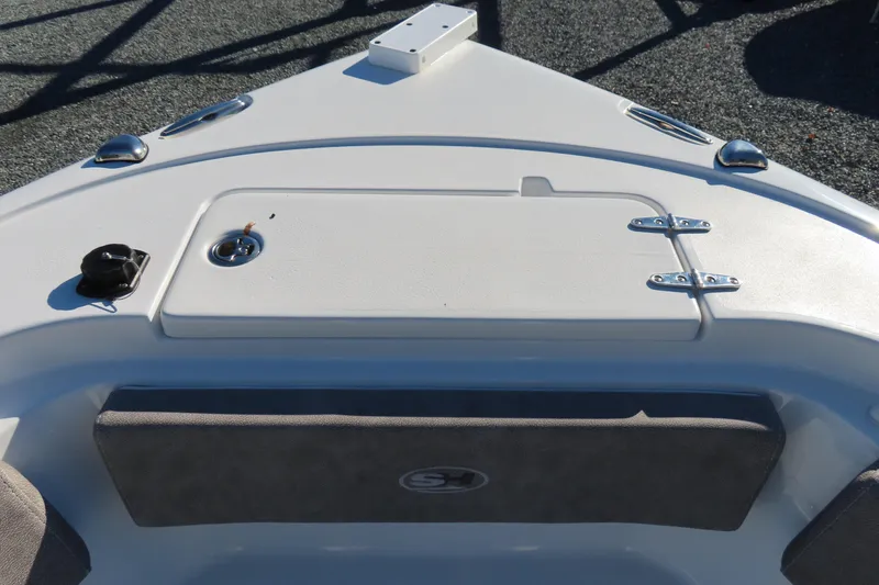 Slide: The Image of 2025 Sea Hunt Ultra 245 SE boat deck with storage compartment and sleek design. - 12