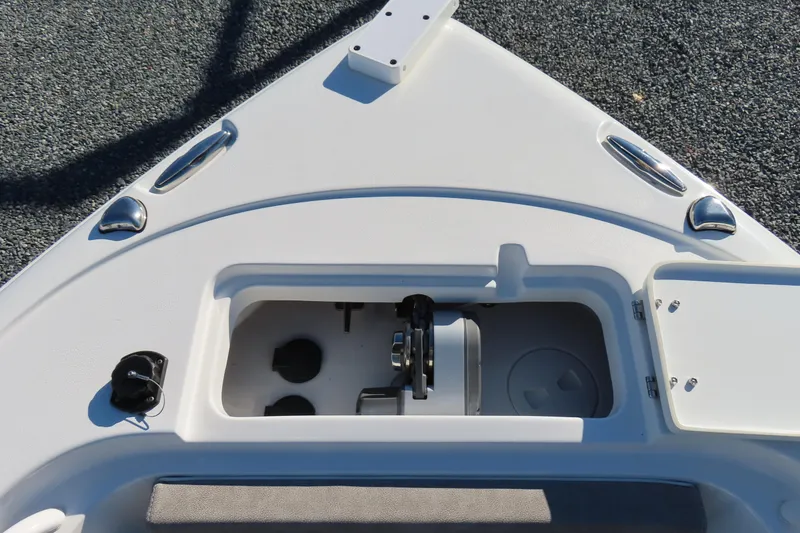 Slide: The Image of 2025 Sea Hunt Ultra 245 SE boat deck with storage compartment and fittings. - 13