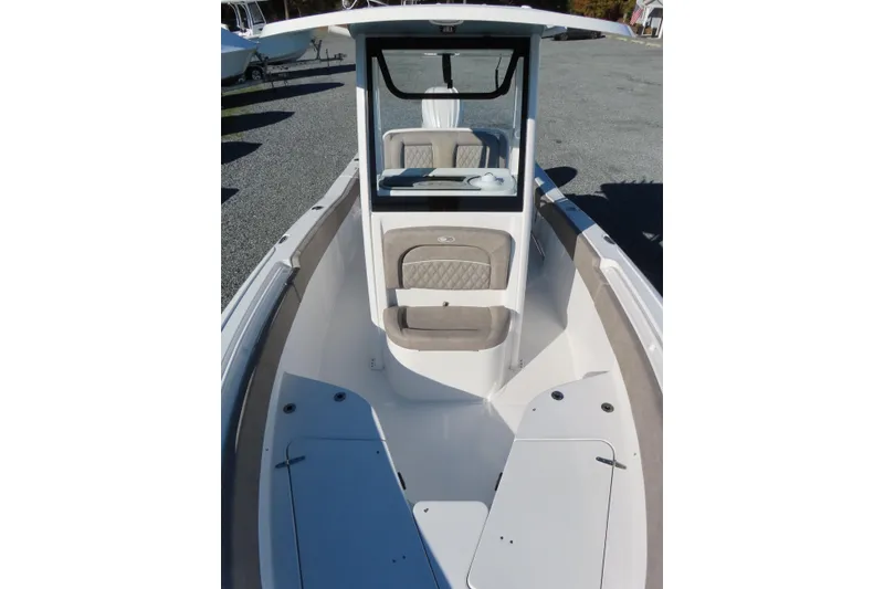 Slide: The Image of 2025 Sea Hunt Ultra 245 SE boat interior with seating and console. - 14