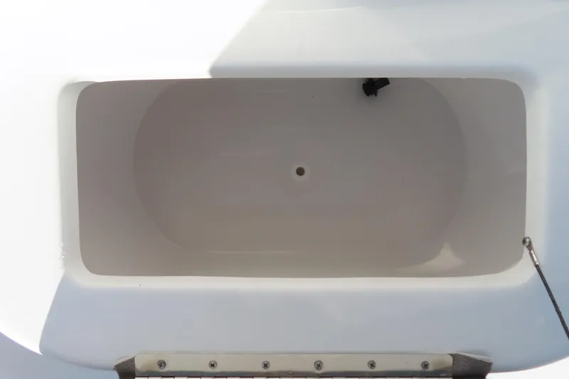 Slide: The Image of 2025 Sea Hunt Ultra 245 SE boat storage compartment, white interior, top view. - 18