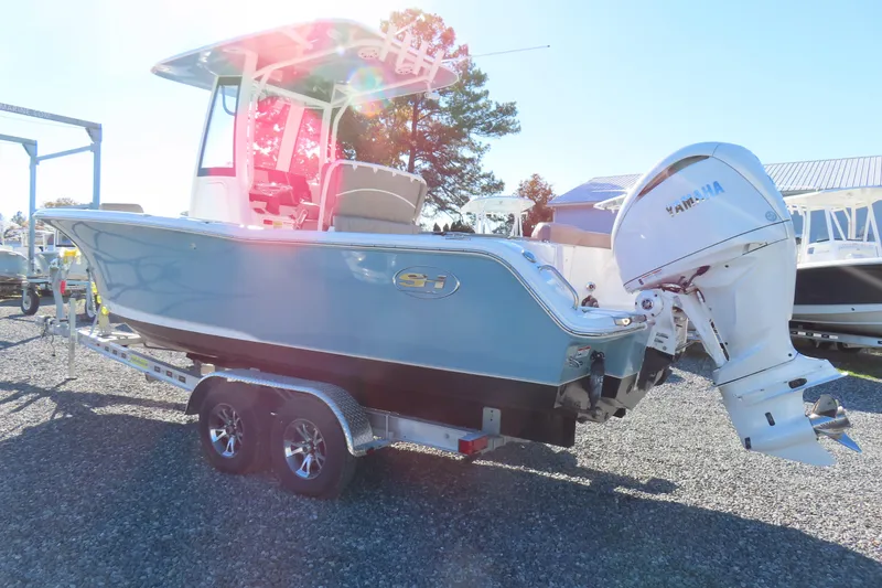 Slide: The Image of 2025 Sea Hunt Ultra 245 SE boat on trailer with Yamaha outboard motor. - 2