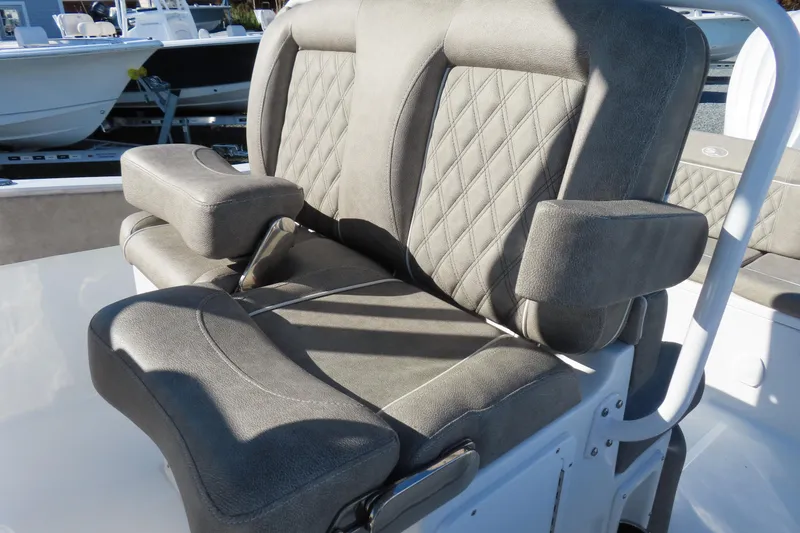 Slide: The Image of 2025 Sea Hunt Ultra 245 SE boat seat with gray upholstery and diamond stitching. - 22