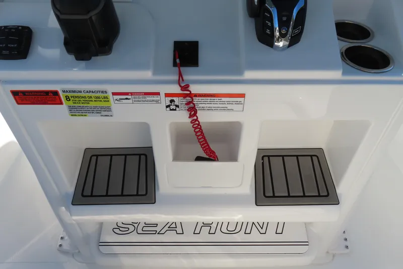 Slide: The Image of 2025 Sea Hunt Ultra 245 SE boat console with controls and safety warnings. - 25