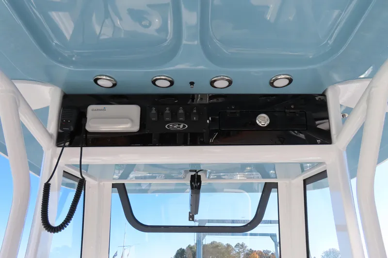 Slide: The Image of 2025 Sea Hunt Ultra 245 SE boat console with Garmin electronics and overhead lighting. - 26