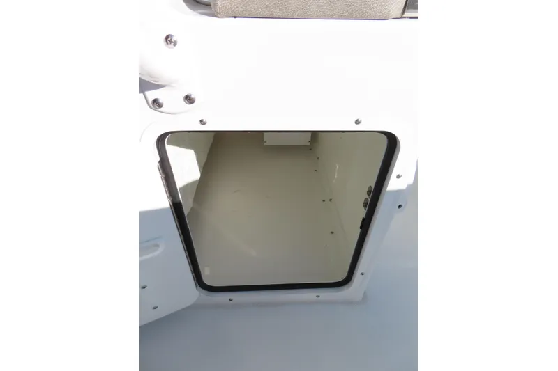 Slide: The Image of Storage compartment on 2025 Sea Hunt Ultra 245 SE boat, open and empty. - 28