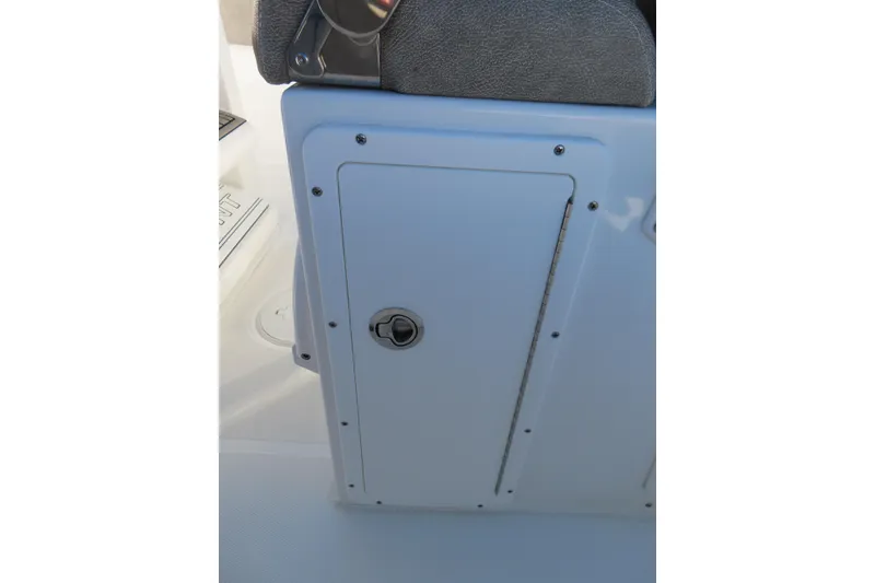 Slide: The Image of 2025 Sea Hunt Ultra 245 SE storage compartment with secure latch and sleek design. - 29