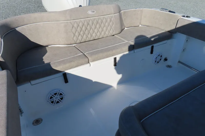 Slide: The Image of 2025 Sea Hunt Ultra 245 SE boat interior with cushioned seating and speakers. - 31