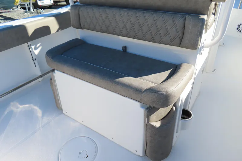 Slide: The Image of 2025 Sea Hunt Ultra 245 SE boat seating with gray upholstery and storage compartment. - 32