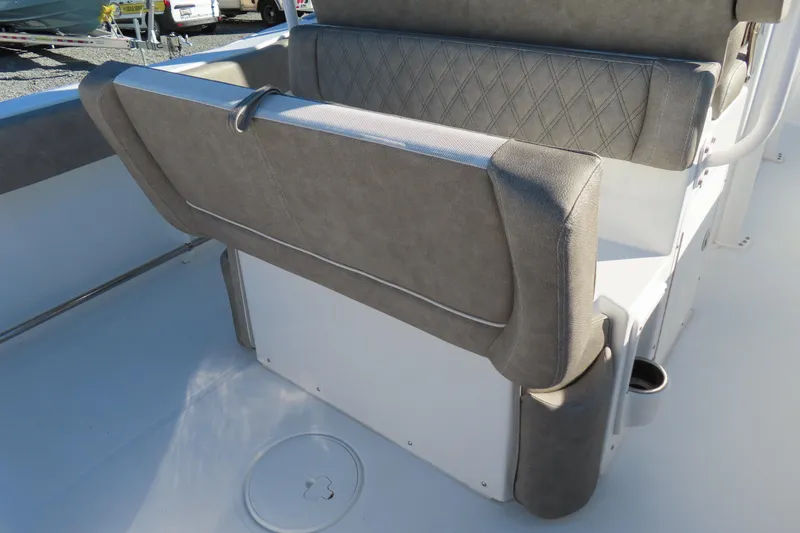 Slide: The Image of 2025 Sea Hunt Ultra 245 SE boat seating with gray upholstery and cup holder. - 33
