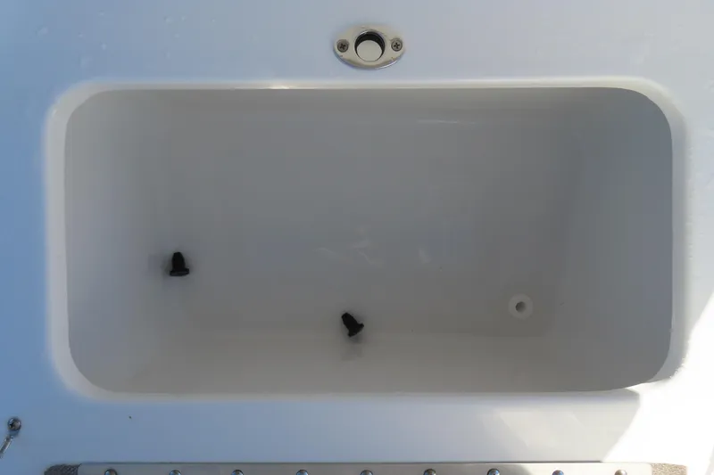 Slide: The Image of 2025 Sea Hunt Ultra 245 SE boat storage compartment, white interior, top view. - 34