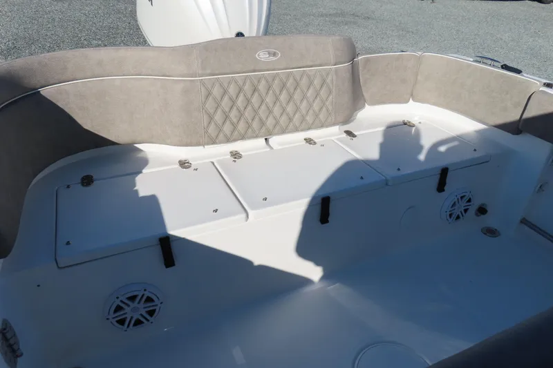 Slide: The Image of 2025 Sea Hunt Ultra 245 SE boat interior with cushioned seating and storage compartments. - 36