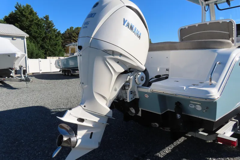 Slide: The Image of 2025 Sea Hunt Ultra 245 SE boat with Yamaha outboard motor in a sunny outdoor setting. - 4