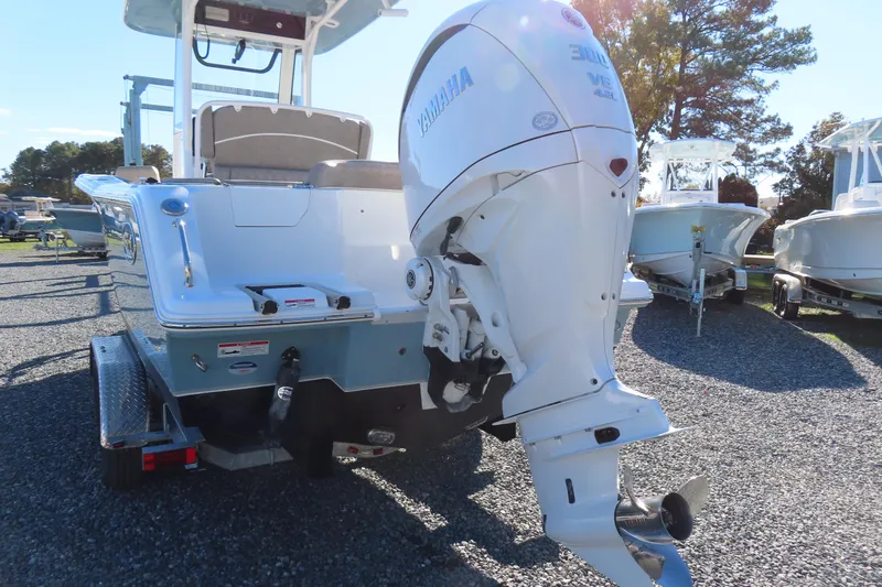 Slide: The Image of 2025 Sea Hunt Ultra 245 SE boat with Yamaha outboard motor on trailer. - 5