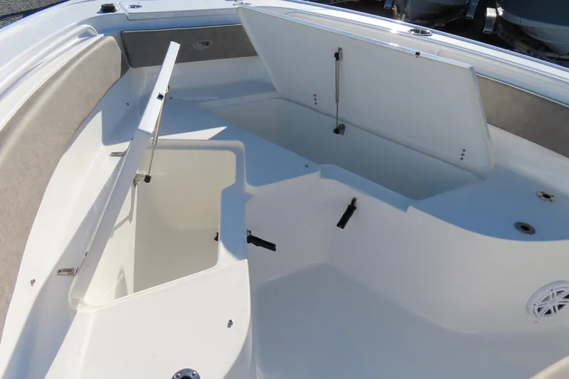 Slide: The Image of 2025 Sea Hunt Ultra 245 SE boat with open storage compartments. - 9