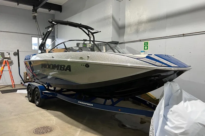 The Image of 2022 Moomba Mojo boat in a garage, on a trailer, with sleek design and modern features. - 0