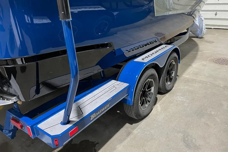 Slide: The Image of 2022 Moomba Mojo boat on a blue trailer, parked indoors. - 4