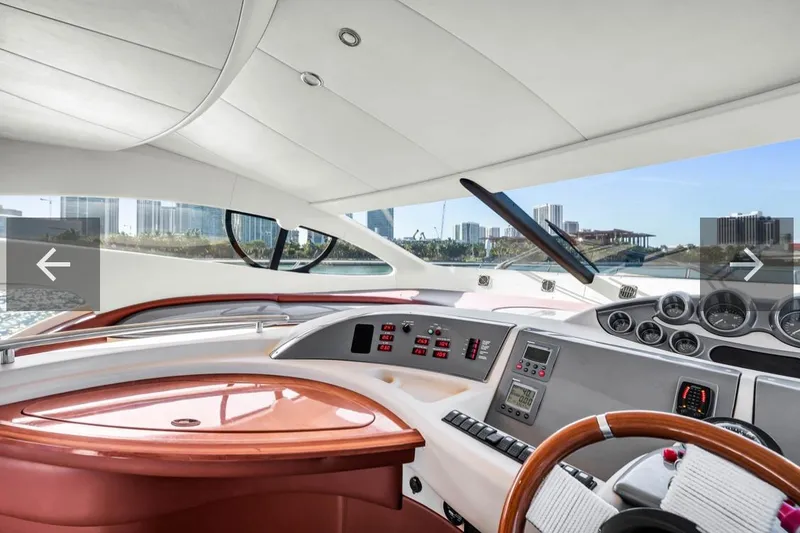 Slide: The Image of Interior view of 2006 Azimut Fly yacht cockpit with modern controls and city skyline. - 11