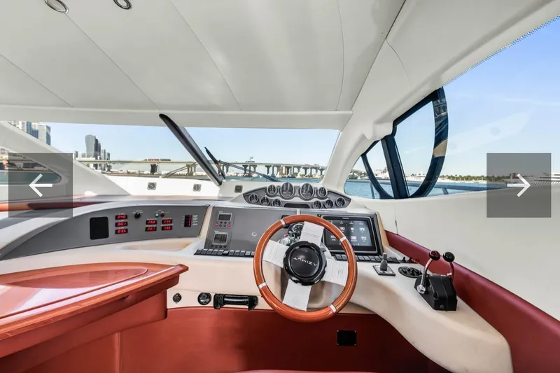 Slide: The Image of Interior view of 2006 Azimut Fly yacht cockpit with modern controls and steering wheel. - 14