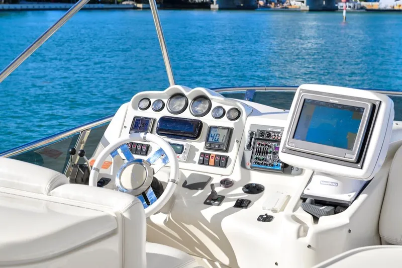 Slide: The Image of Cockpit of 2006 Azimut Fly yacht with navigation equipment and steering wheel. - 19
