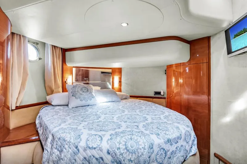 Slide: The Image of Luxurious bedroom interior of 2006 Azimut Fly yacht with elegant bedding and wood finishes. - 23